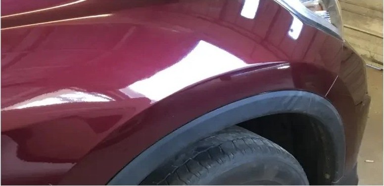 Maroon fender after paintless dent repair