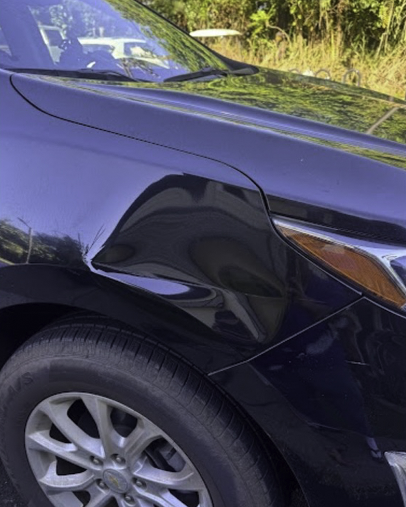 SUV front panel before paintless dent repair
